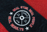 Black towel with gym-themed text and weight design on a red background